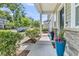 Inviting front porch with stone accents, lush landscaping, and vibrant blue planters flanking the entryway at 4235 Scharite St, Charleston, SC 29414