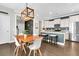 Open concept kitchen and dining area with modern lighting, granite countertops and stainless refrigerator at 4235 Scharite St, Charleston, SC 29414