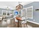 Open-concept living and dining area with hardwood floors and modern lighting at 4235 Scharite St, Charleston, SC 29414