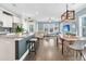 Spacious living area with a kitchen island, dining area, and plenty of natural light from large windows at 4235 Scharite St, Charleston, SC 29414