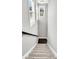 Clean staircase with plush carpet leading to a dark wood landing and ample natural light at 4235 Scharite St, Charleston, SC 29414
