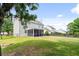 Large, fenced backyard featuring a screened-in porch and mature trees at 428 Cabrill Dr, Charleston, SC 29414