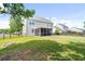 Large, fenced backyard with a screened-in porch and mature trees and lush grass at 428 Cabrill Dr, Charleston, SC 29414