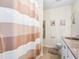 Bathroom featuring a shower with decorative curtain, white fixtures, and neutral walls at 428 Cabrill Dr, Charleston, SC 29414