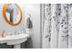 Half bath with circular mirror and white vanity at 428 Cabrill Dr, Charleston, SC 29414
