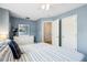 Comfortable bedroom features blue walls, white trim, ceiling fan and ensuite bathroom at 428 Cabrill Dr, Charleston, SC 29414