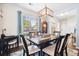 Bright dining room with stylish chandelier, large window and dark wood table at 428 Cabrill Dr, Charleston, SC 29414