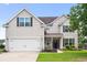 Charming two-story home with a well-manicured lawn, white garage door and black shutters at 428 Cabrill Dr, Charleston, SC 29414