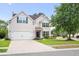 Charming two-story home with a well-manicured lawn, white garage door and black shutters at 428 Cabrill Dr, Charleston, SC 29414