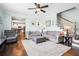 Cozy living room with neutral furnishings, hardwood floors, a ceiling fan, and an open staircase at 428 Cabrill Dr, Charleston, SC 29414