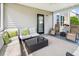 A cozy screened porch with wicker furniture and a dark glass coffee table at 428 Cabrill Dr, Charleston, SC 29414
