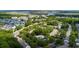 An aerial view of a quiet neighborhood with a community pool surrounded by lush greenery and scenic waterways at 432 Doane Way, Wando, SC 29492