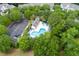 Aerial view of a community pool and clubhouse surrounded by trees and parking at 432 Doane Way, Wando, SC 29492