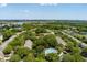 Scenic aerial view of homes in a serene community, featuring mature trees and a sparkling neighborhood pool at 432 Doane Way, Wando, SC 29492