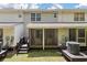 Exterior of home featuring a screened-in porch and backyard with green grass at 432 Doane Way, Wando, SC 29492