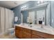 Bathroom with double sink vanity, neutral tile flooring, and large mirror with great lighting at 432 Doane Way, Wando, SC 29492