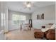 Bright bedroom featuring a ceiling fan, a desk by the window, and a leather armchair with a blanket at 432 Doane Way, Wando, SC 29492