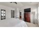Spacious bedroom with a ceiling fan, warm carpet, and adjacent bathroom access creating a comfortable retreat at 432 Doane Way, Wando, SC 29492