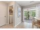 Bright breakfast nook with sliding glass doors leading to screened porch, and adjacent laundry closet at 432 Doane Way, Wando, SC 29492