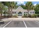 Exterior view of a neighborhood clubhouse surrounded by palm trees with parking available at 432 Doane Way, Wando, SC 29492