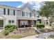 Charming brick and siding townhome featuring a cozy front porch and manicured landscaping at 432 Doane Way, Wando, SC 29492