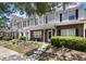Charming brick and siding townhome featuring a cozy front porch and manicured landscaping at 432 Doane Way, Wando, SC 29492