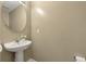 Functional half bathroom with a pedestal sink, oval mirror and a neutral color palette at 432 Doane Way, Wando, SC 29492
