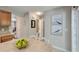 Kitchen with wooden cabinetry, an island with seating, and access to additional rooms and a half bath at 432 Doane Way, Wando, SC 29492