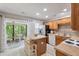 Bright kitchen with an island, modern appliances, and sliding door access to the balcony at 432 Doane Way, Wando, SC 29492