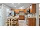 Traditional kitchen with wooden cabinets, stainless steel refrigerator, and a tiled backsplash at 432 Doane Way, Wando, SC 29492