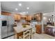 Cozy kitchen featuring wooden cabinets, stainless steel refrigerator, and an island with barstool seating at 432 Doane Way, Wando, SC 29492