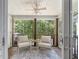 Relaxing screened porch featuring wood floors, ceiling fan and cozy wicker seating with wooded view at 432 Doane Way, Wando, SC 29492