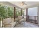 Inviting screened porch with wood floors, ceiling fan and comfortable wicker seating overlooking a wooded backyard at 432 Doane Way, Wando, SC 29492