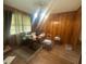 Dining room with wood-paneled walls, tile floors, and a traditional chandelier at 4462 Hardwood St, Ladson, SC 29456