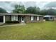 Charming single-story brick home featuring a well-maintained lawn and classic black shutters at 4462 Hardwood St, Ladson, SC 29456