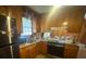 Cozy kitchen featuring wood cabinets, laminate countertops, and a stainless-steel refrigerator at 4462 Hardwood St, Ladson, SC 29456