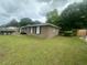 Side yard showcasing the property's lush green lawn and brick exterior at 4462 Hardwood St, Ladson, SC 29456
