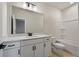 Bright bathroom with white cabinetry, quartz countertop, large mirror and shower over tub at 459 White Magnolia St, Moncks Corner, SC 29461