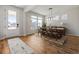 Bright dining area featuring hardwood floors, modern lighting, and large windows offering ample natural light at 459 White Magnolia St, Moncks Corner, SC 29461