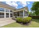 A well manicured backyard with a patio, exterior view of the screened porch, and tasteful landscaping at 465 Blue Dragonfly Dr, Charleston, SC 29414