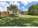 Large, fenced backyard with lush green grass and a screened-in porch perfect for outdoor entertaining at 465 Blue Dragonfly Dr, Charleston, SC 29414