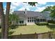 A large backyard with green grass, a small patio, and view of the screened in porch from an aerial view at 465 Blue Dragonfly Dr, Charleston, SC 29414