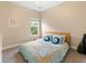 Bright bedroom featuring a neatly made bed with patterned bedding, a window with natural light, and neutral wall color at 465 Blue Dragonfly Dr, Charleston, SC 29414