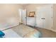 Bedroom with a double door closet, view to another room, neutral walls, and a neatly made bed at 465 Blue Dragonfly Dr, Charleston, SC 29414