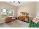 Sunlit bedroom with neutral carpet and stylish mid-century modern furniture at 465 Blue Dragonfly Dr, Charleston, SC 29414