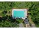 Aerial view of a community pool, with lounge chairs, surrounded by lush greenery and trees at 465 Blue Dragonfly Dr, Charleston, SC 29414