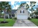 Charming single-Gathering home with a well-manicured lawn, two car garage, and lush landscaping at 465 Blue Dragonfly Dr, Charleston, SC 29414