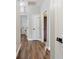 Bright hallway with hardwood floors and several doors leading to other rooms at 465 Blue Dragonfly Dr, Charleston, SC 29414