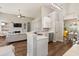 Open-concept kitchen with an island, white cabinetry, and views into the living room at 465 Blue Dragonfly Dr, Charleston, SC 29414