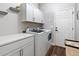 Functional laundry room with white cabinetry, quartz countertop, and modern washer and dryer at 465 Blue Dragonfly Dr, Charleston, SC 29414